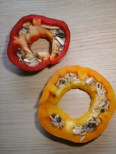 two peppers cut in half sitting on top of a table