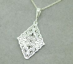 "All of our jewelry is guaranteed authentic by our Graduate Gemologist of the Gemological Institute of America (GIA). 935 Argentium Sterling Diamond Shaped Pendant (#J4413) New custom designed laser cut argentium 935 sterling pendant. Argentium is a higher grade sterling that is a tarnish resistant formula. Includes new 18\" sterling chain. Pendant measures 1 3/4\" long and weighs 2.8dwt. See out other listing for the matching earrings SKU#J4406. Fabulous! INV#NZ4543. SKU#J4413. 100% Satisfactio Elegant Laser Cut Jewelry As A Gift, Elegant Laser Cut Jewelry For Gifts, Elegant Laser Cut Jewelry Gift, Classic Silver Diamond-shaped Jewelry, White Laser-cut Jewelry For Gifts, Sterling Silver Flatware, Earrings Design, Big Bend, Cameo Pendant