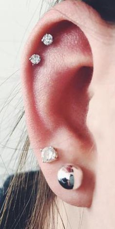 a woman with three piercings on her ear