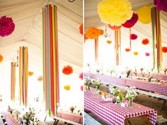 the tables are decorated with paper flowers and tissue pom poms