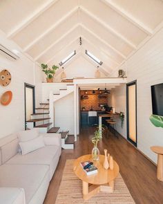 a living room filled with furniture and a flat screen tv on top of a wooden table