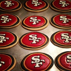 cookies decorated with red and white icing in the shape of san francisco giants logos