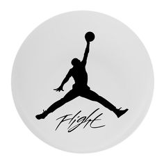 a white plate with a black and white image of a basketball player holding a ball