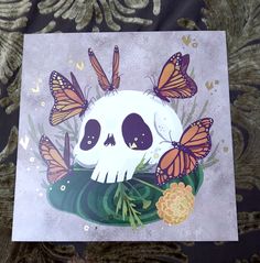 a card with a skull and butterflies on it