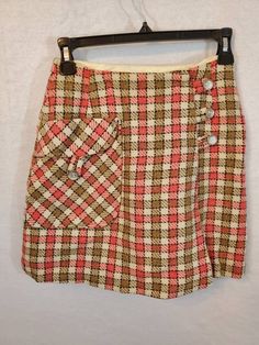 "Super cute vintage skirt! Vintage Mini Skirt Plaid Tan Pink with buttons. No tag. Waist 12\" length 16\" Piece may have stains or spots, as expected with vintage item. See photos for some, but not necessarily all of the spots." Fitted Vintage Mini Skirt With Pockets, Retro Bottoms With Button Closure, Retro Fall Bottoms With Buttons, Vintage Fall Skirt With Pockets, Vintage Skirt For Fall, Retro Mini Skirt With Pockets, Retro Fitted Mini Skirt With Button Closure, Retro Mini Skort For Fall, Vintage Fall Skirt With Buttons