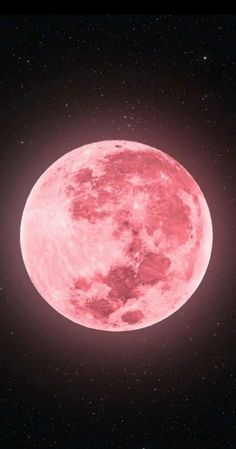 a pink moon in the sky with stars around it