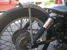 the front wheel of a motorcycle parked in a parking lot