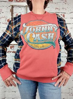 Johnny Cash Ring of Fire upcycled shirt. Would fit ladies LG/XL and probable a mens med.  This is made from three shirts, orange sweatshirt, plaid flannel and a gray t shirt that had the logo. Cuffs and bottom band reattached to sweatshirt. So fun and unique.  Bust-50 Sleeve-19 Machine wash and dry To see more upcycled clothing visit https://www.etsy.com/shop/RejuvenatedThreadsCo Flannel Rework, Reworked Cotton Long Sleeve Tops, Reworked Cotton Crew Neck Tops, Reworked Flannel Shirt, Reworked Sweatshirts, Johnny Cash Shirt, Vintage Reworked Plaid Tops, Reworked Flannel, Reworked Clothing