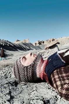 a woman laying on the ground with her eyes closed