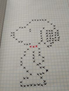 an open book with cross stitch designs on the pages and red dots in the middle