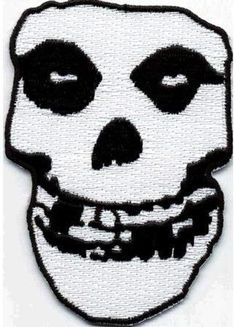 a white and black patch with a skull on it's face in the shape of a human head