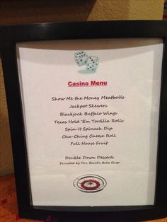 a casino menu with two dices on the table next to it in a black frame