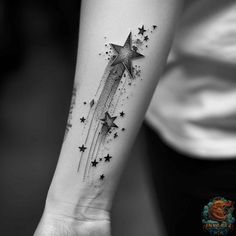 a woman's arm with stars on it