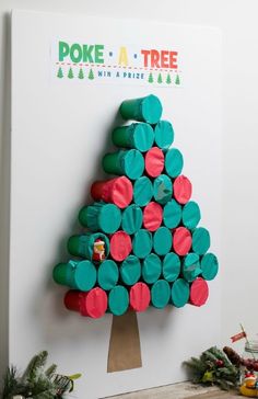 a christmas tree made out of toilet paper rolls on top of a white board with green and red circles