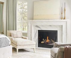 a living room filled with furniture and a fire place in the middle of the room