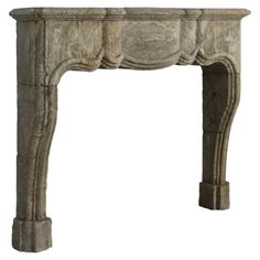 an old stone fireplace mantel with carvings on the top and sides, isolated against a white background