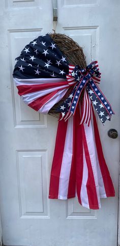 an american flag wreath hanging on the front door