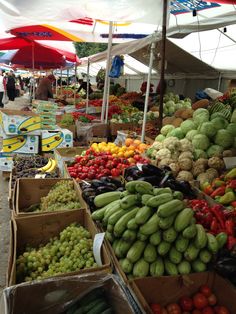 an open air market with lots of fruits and vegetables