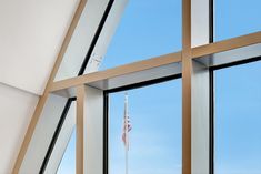 an american flag is seen through the windows of a modern office building in washington, d c