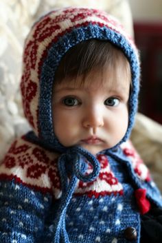 an image of a baby wearing a knitted hat and scarf on the facebook page