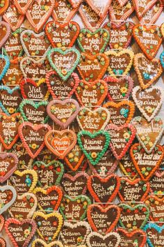 many heart shaped cookies are on display for sale