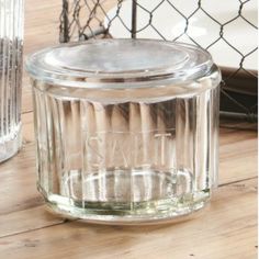 a glass jar sitting on top of a wooden table