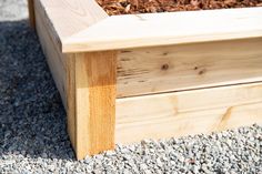 a wooden bench sitting on top of gravel