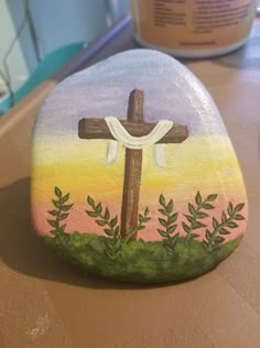 a painted rock with a cross on it