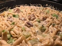 a skillet filled with pasta and meatballs