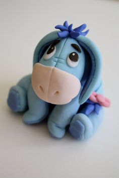 a blue toy dog sitting on top of a white table