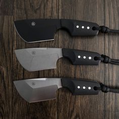 three knives with black handles on a wooden table