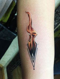 a tattoo on the arm of a person with a burning match in it's center