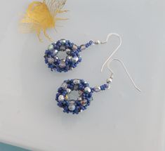 These beautifully sparkly drop earrings are hand stitched from tiny matte glass seed beads in a stunning blue colour with a hint of purple and Czech glass faceted beads and crystals to form lovely circles with silver rainbow coloured accents.  They really do shine as the light catches them. They are approx 2.5cm long not including the earwires, which are sterling silver I have also made a golden version of these which are available here: https://www.etsy.com/uk/listing/1122739991 Why not take a Blue Wire Wrapped Beaded Earrings, Blue Wire Wrapped Round Beaded Earrings, Blue Round Wire Wrapped Beaded Earrings, Blue Round Beaded Earrings With Spacer Beads, Crystal Beaded Earrings With Faceted Round Beads, Blue Beaded Round Crystal Earrings, Blue Beaded Czech Glass Crystal Earrings, Blue Beaded Crystal Earrings With Round Beads, Crystal Heart Earrings