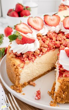 a cheesecake with strawberries and whipped cream on top