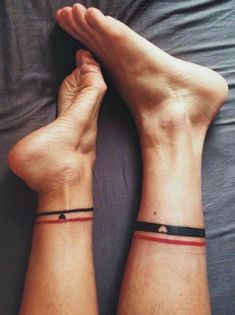 two people with matching wristbands sitting on a bed