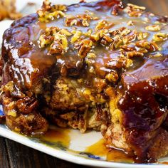 a plate topped with meat covered in gravy and pecanized walnuts