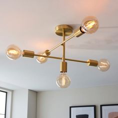 a chandelier hanging from the ceiling in a living room