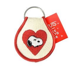 a small red and white bag with a dog on it's face in the shape of a heart