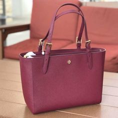 Brand New With Tags Attached (100% Authentic) Style: Tory Burch Emerson Small Tote Bag (Imperial Garnet) Material: Saffiano Leather Features: 2 Interior Slip Pockets And 1 Zip Pocket, Dual Handles 8.5″ Drop 20″ Drop Adjustable/Detachable Crossbody Strap Measures: 35.56cm L X 22.86cm H X 12.7cm W Red Epsom Leather Rectangular Bag, Red Rectangular Epsom Leather Bag, Epsom Leather Shoulder Bag With Gold-tone Hardware For Shopping, Formal Red Epsom Leather Bag, Red Saffiano Leather Bag For Everyday Use, Red Saffiano Leather Shopping Bag, Elegant Red Saffiano Leather Shoulder Bag, Classic Red Saffiano Leather Bag, Red Saffiano Leather Bag For Daily Use