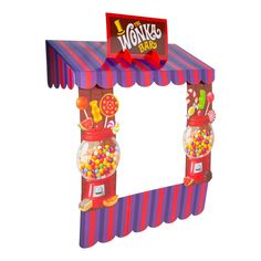 a colorful candy machine with a sign on top