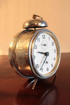 an alarm clock sitting on top of a wooden table