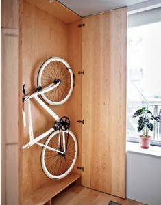 a bike mounted to the side of a wooden wall