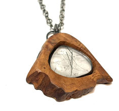 This eye-catching Cherry Rutilated Quartz Necklace will be the envy of any jewelry collection. Featuring cherry wood framing a stunning piece of rutilated quartz set in sterling silver, this statement piece will make a lasting impression. On an adjustable 24" sterling chain Quartz Raw Stone Healing Necklaces, Quartz Raw Stone Pendant Necklace, Raw Quartz Necklace, Rutilated Quartz Necklace, Rutilated Quartz, Quartz Necklace, Cherry Wood, Statement Pieces, Jewelry Collection