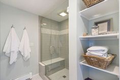 a walk in shower sitting next to a bathroom sink