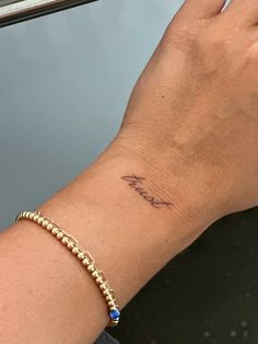 a woman's arm with a tattoo on it and a bracelet that says, i love you