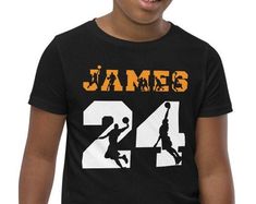 a young boy wearing a black shirt with the number 24 on it