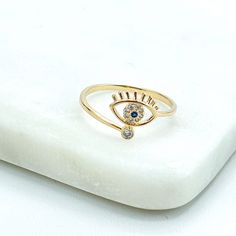 18k Gold Filled Clear & Blue Cubic Zirconia Details on Front Evil Eye Shape Protective Ring, Wholesale Jewelry Making Supplies. Ring Size: -Thickness: 1mm | Hand Thickness: 2mm | Hand Width: 18mm  | Evil Eye: 7mm x 9mm 💎 With new products daily, quality and competitive  prices, in DiJu Jewelry you find the most unique styles of modern designs, always looking for elegance and market trends.   *Helping your Jewelry Businesses Grow *Starting your Own Business *Making your Own Collection: DiJu Jewelry ever brings Better Moments for your Life.   📲 Find many more styles in our DiJu Jewelry Etsy Store. https://www.etsy.com/shop/DJDiJuJewelry   💎 You can choose from unique styles of earrings, necklaces, pendants and charms, bracelets, anklets, rings, chokers, and many others. On the off chance Gold Plated Blue Rings As Gift, Blue Gold Plated Rings As Gift, Blue Gold Plated Rings For Gift, Blue Gold-plated Rings For Gifts, Gold Rings With Diamond Eyes For Promise, Gold Promise Ring With Diamond Eyes, Gold Rings With Diamond Eyes For Anniversary, Gold Sapphire Ring With Cubic Zirconia Gift, Gold Evil Eye Promise Ring