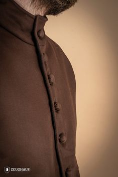 Our 15th-century-style arming doublet is designed to fit into any armor set with ease, providing a secure fit and sturdy anchorage for the legs, arms, and shoulders. Crafted from lightweight yet resilient cotton, it offers superior comfort and protection. • Dyed with natural dyes. For best results, wash by hand with cold water and mild detergent. We also advise turning the garment over to protect the garment’s outer side. • External fabric is made up of 100% cotton • Padding is made of 100% poly Medieval Style Fitted Tops For Larp, Medieval Fitted Top For Larp, Fitted Medieval Style Tops For Larp, Fitted Tops With Stand Collar And Button Cuffs, Fitted Tops With Button Cuffs And Stand Collar, Fitted Top With Button Cuffs And Stand Collar, Black Week, Waist Circumference, 15th Century