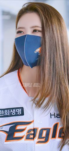 a woman wearing a face mask with an eagle logo on it's front and back