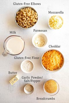 the ingredients to make macaroni and cheese are shown in bowls on a white surface